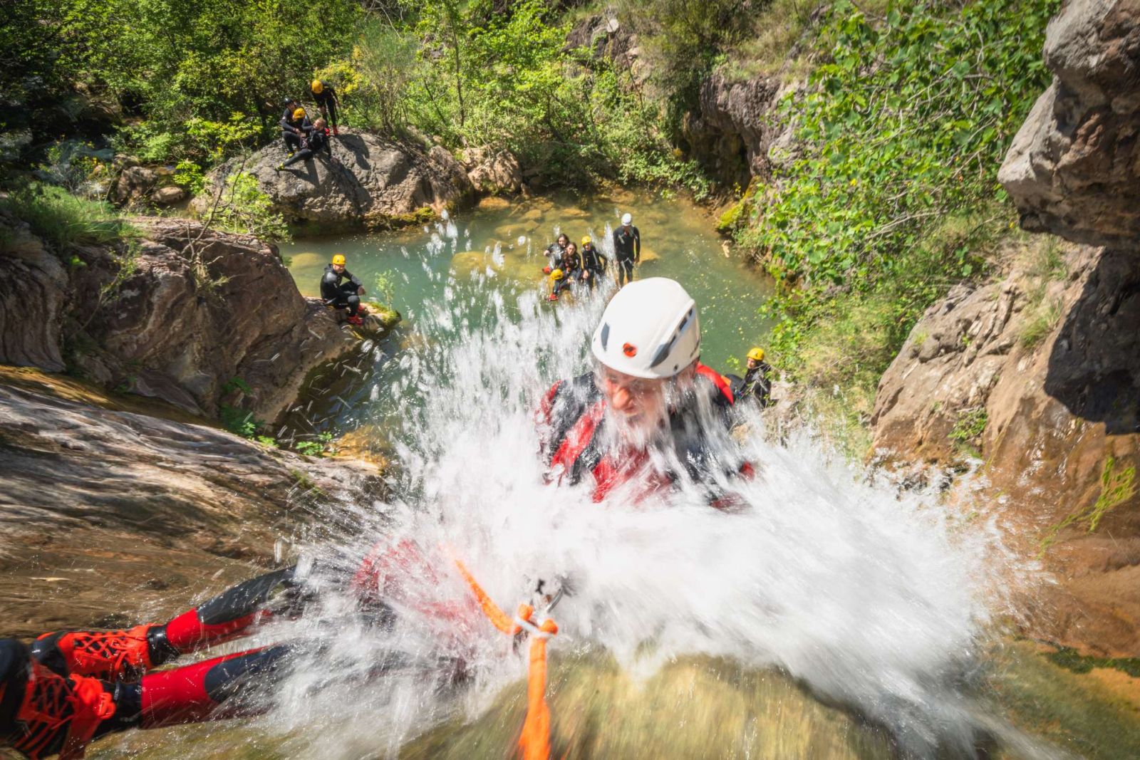 Canyoning group walking downstream
