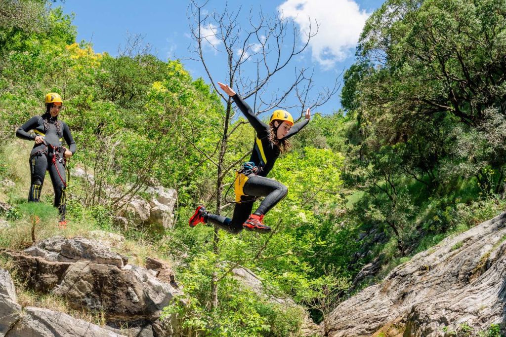 Abseil down a mossy rock face