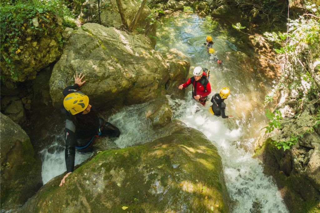 Guest stepping over the lip of a cascade