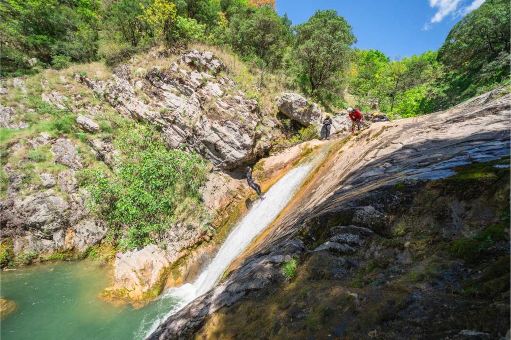 Guest under a small waterfall