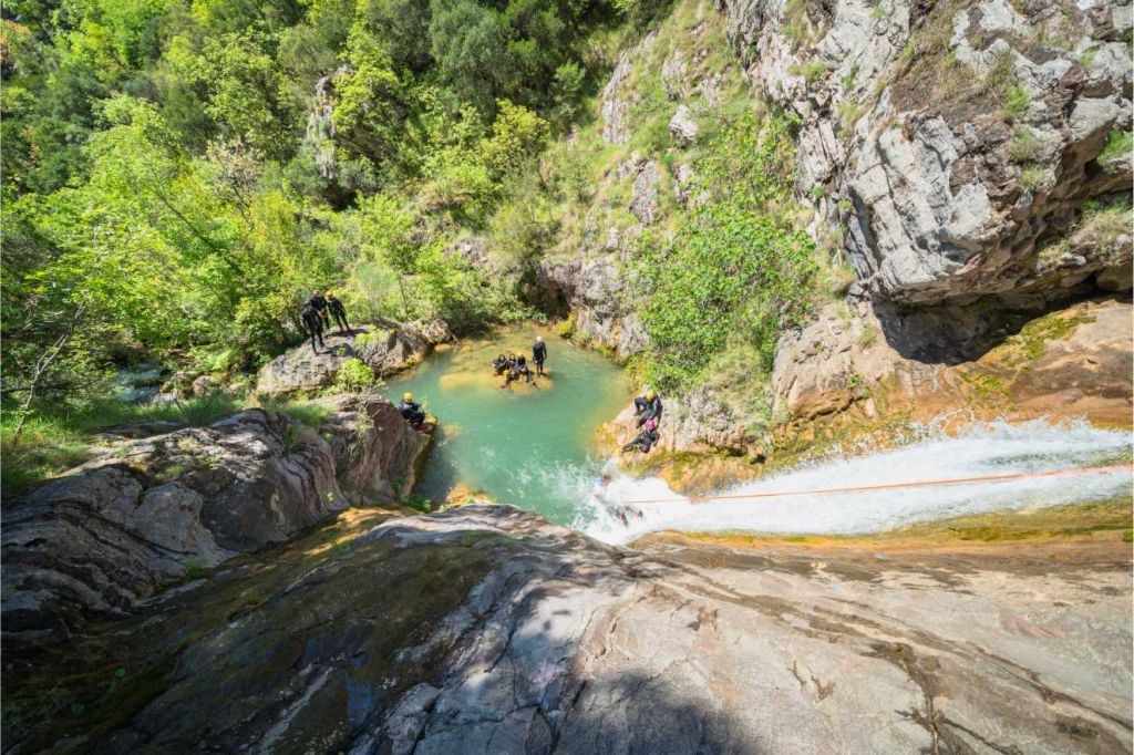 Guest jumping from a ledge into the water