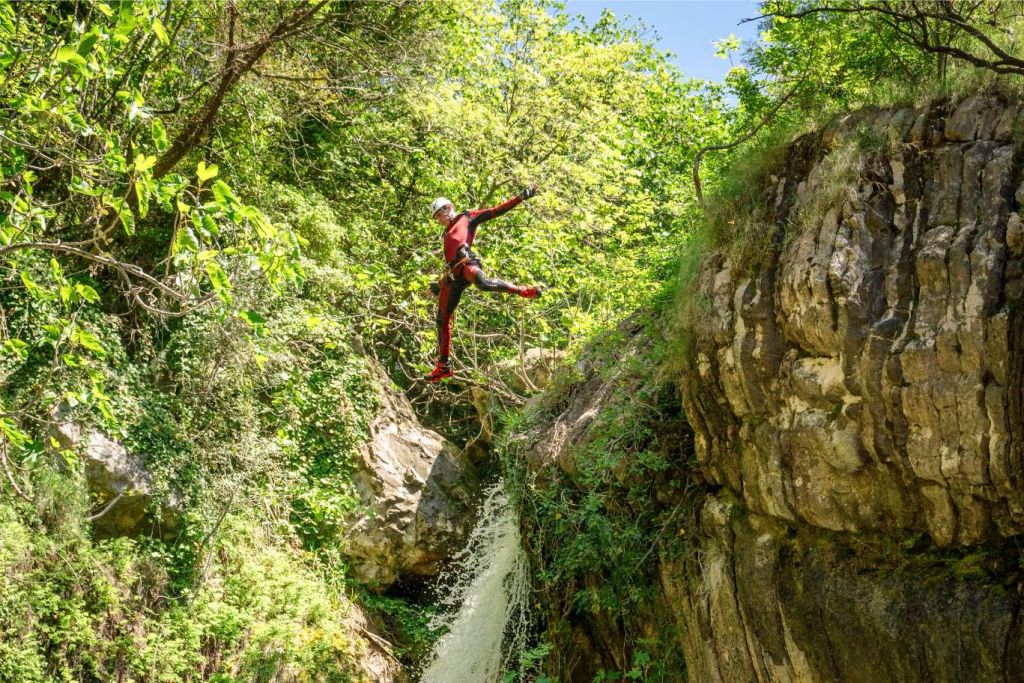Guest wading through clear canyon water
