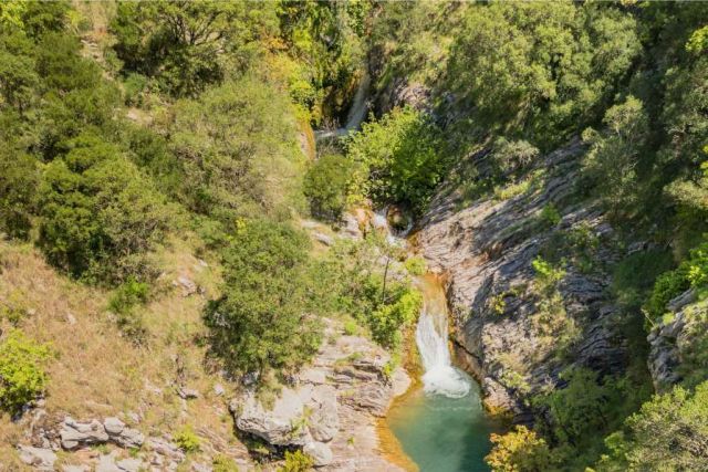 Abseiling down a waterfall in Drenostica Canyon