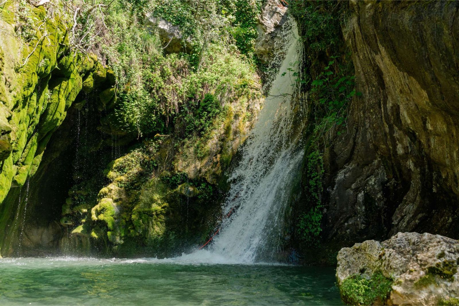 Guest on a rope beside falling water