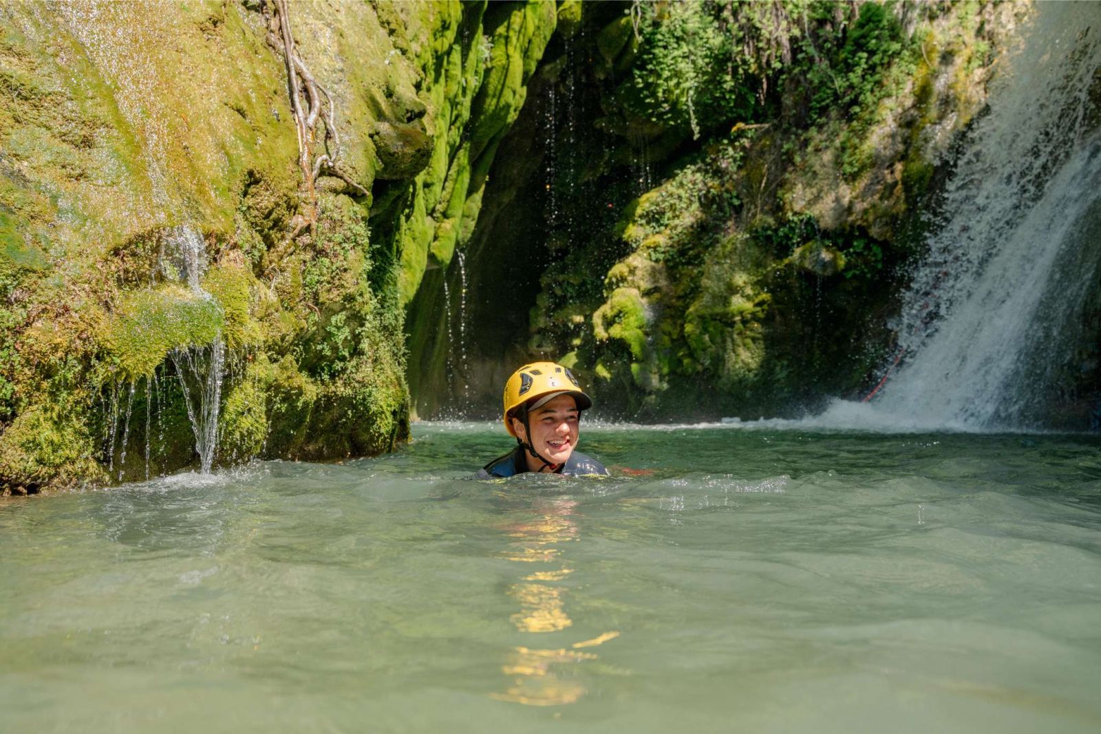 Descending a waterfall on a canyoning rope