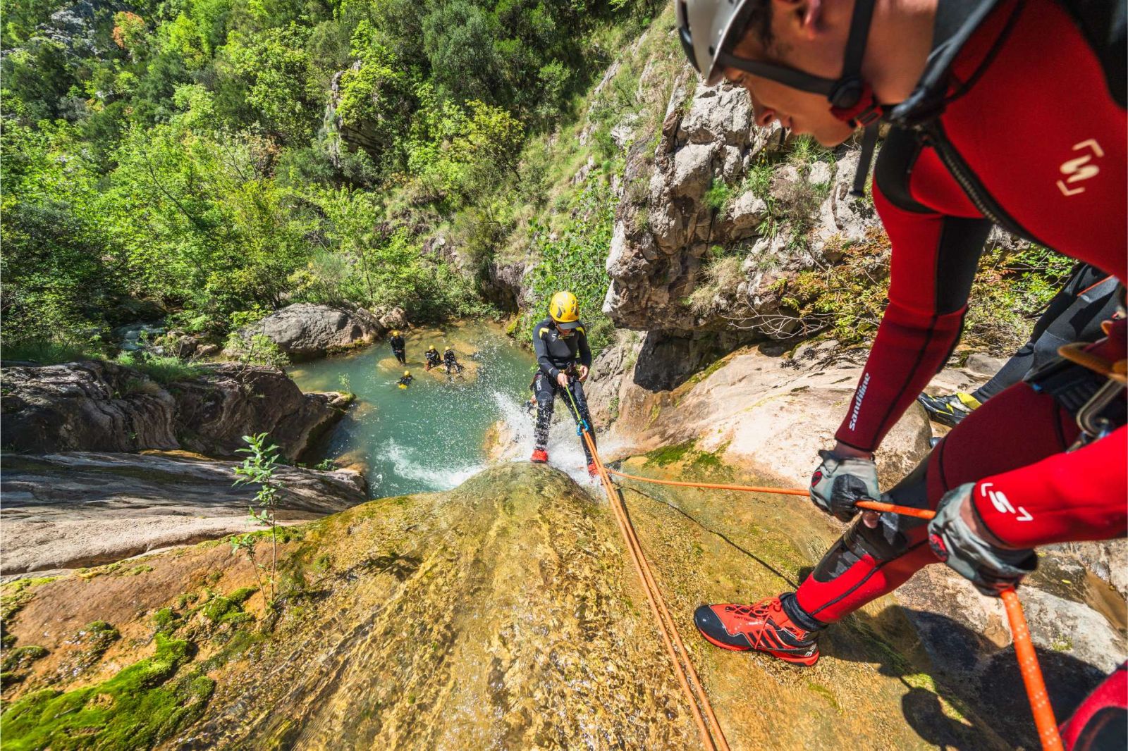 Jumping into a deep green pool in the canyon